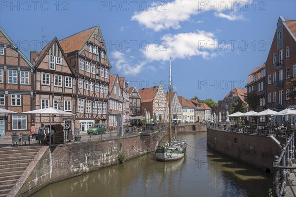 Historic merchant and warehouse houses at the Hanseatic harbour with the sailing ship Willi