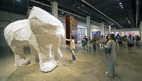 Korean woman touching a Korean artwork