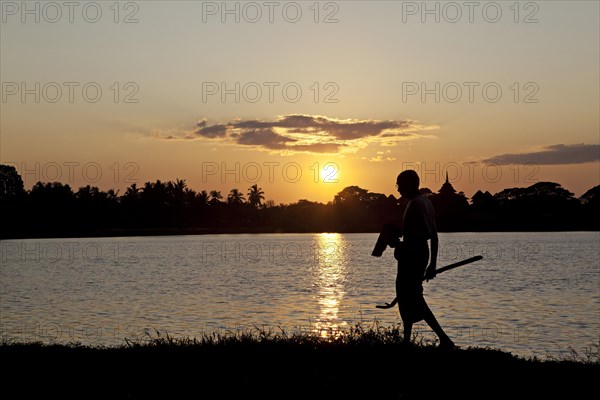Man in sunset by the river