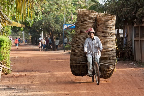 Man transporting many baskets on bicycle