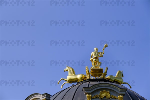 Golden quadriga guided by a torch-bearing Apollo