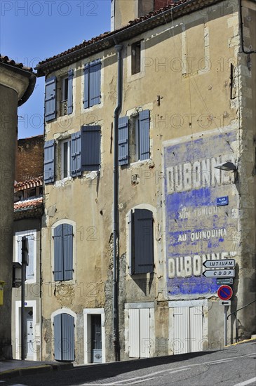 Old advertisement for the aperitif Dubonnet painted on house front at Auch