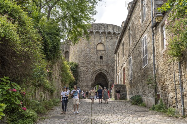 Alley with cobblestones and city wall in the historic old town of Dinan