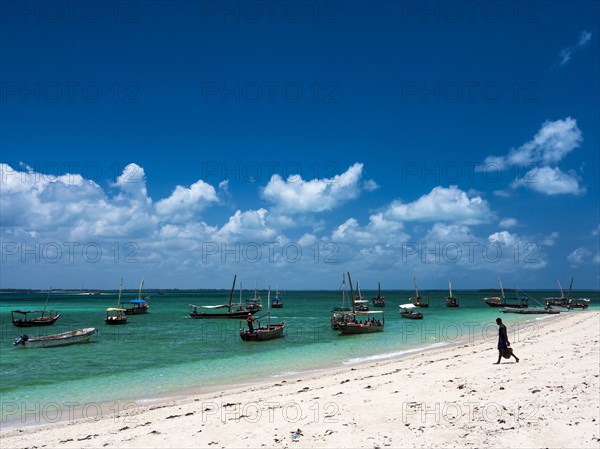 Boats on the white beach in the turquoise sea