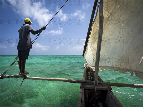 Local man steering outrigger boat