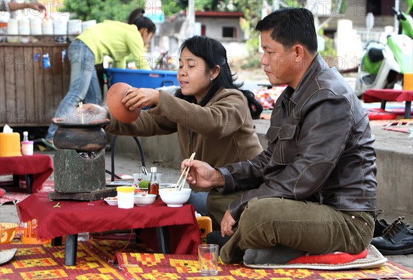 People in a roadside cookshop