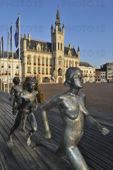 The sculpture group The Runners and town hall at the Market Square in Sint-Niklaas