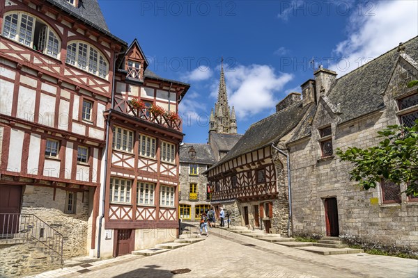 Half-timbered houses and the Basilica Notre-Dame-du-Roncier in the old town of Josselin