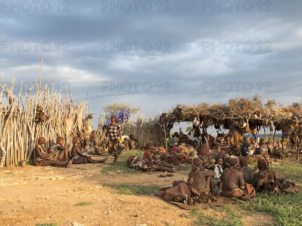 Villagers from the Hamar tribe sitting on the ground