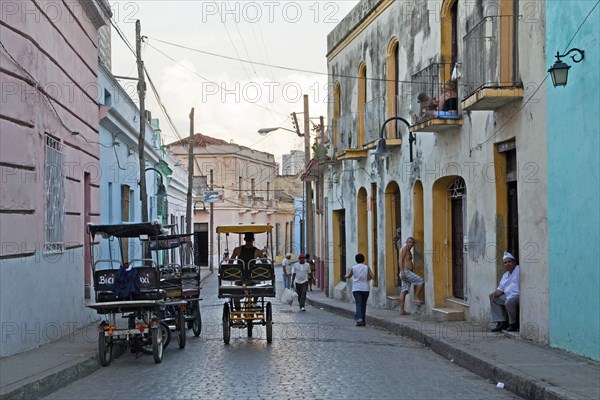 Street scene showing three-wheeled bicycle taxis in the city Camagueey