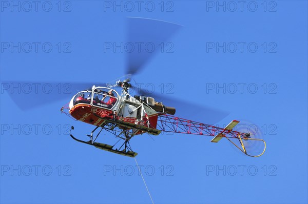 Swiss Aerospatiale SA 315B Lama rescue helicopter of Air Glaciers in flight in the Alps