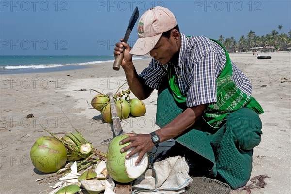 Man opening coconuts on the beach