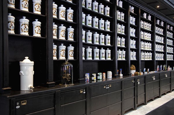 Porcelain jars with medicines and herbs in old pharmacy cabinet of drugstore in the Calle Obispo