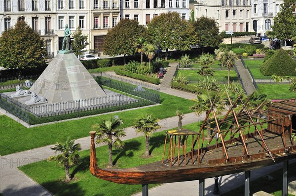 Replica of Egyptian wooden boat and statue of Auguste Mariette in city park at Boulogne-sur-Mer