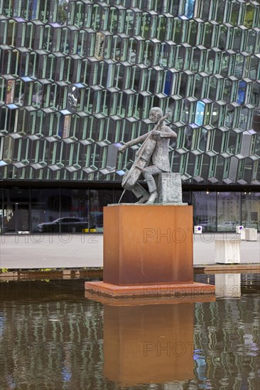 Sculpture The Musician by Icelandic sculptor Oloef Palsdottir in front of Harpa Concert Hall and conference centre in capital city Reykjavik