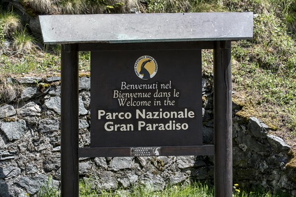 Wooden welcoming board with logo of the Gran Paradiso National Park in the Graian Alps