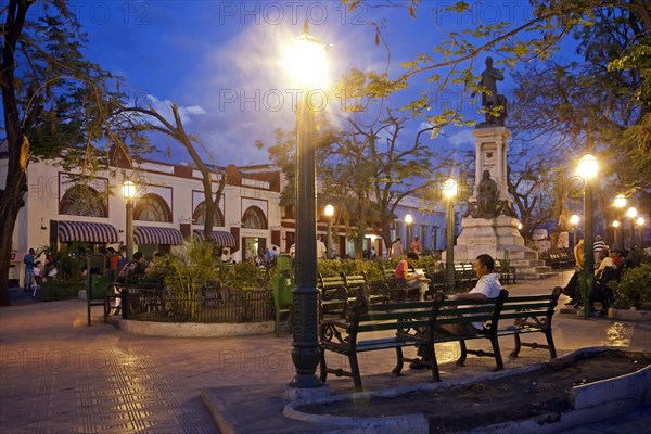 Tourists at colonial square in the evening at Santiago de Cuba