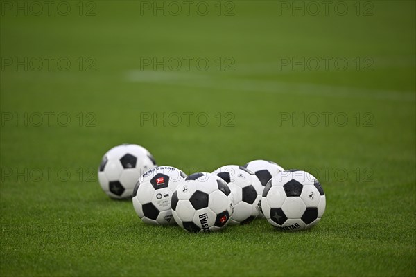 Adidas Derbystar match balls lie on grass