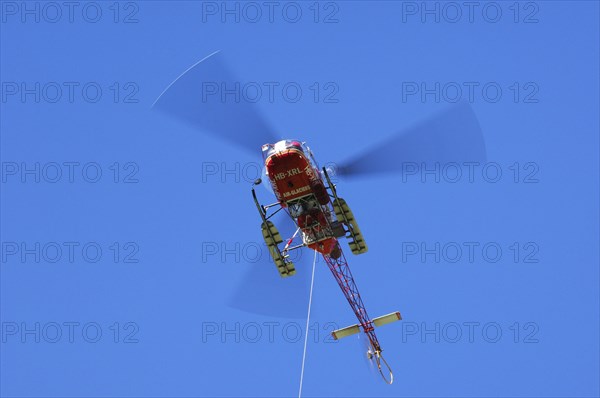 Swiss rescue helicopter in flight in the Alps