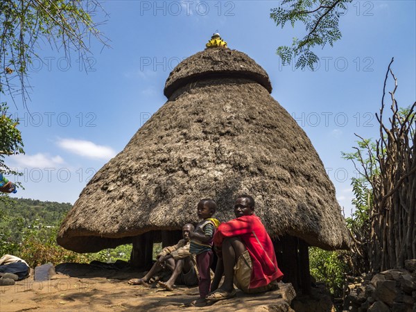 Inhabitants in front of the hut in the village