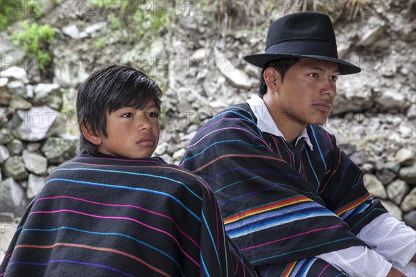 Boy and man with ponchos