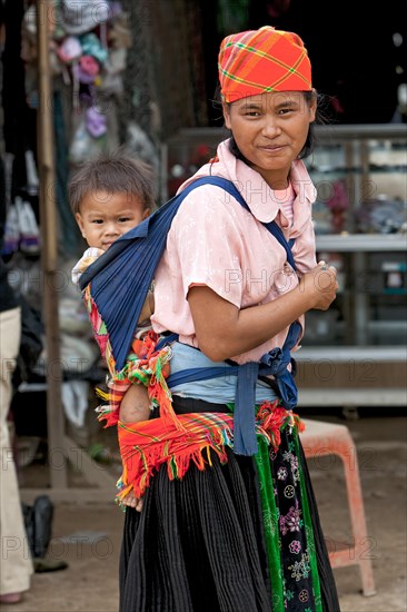 Mother carrying child in sling