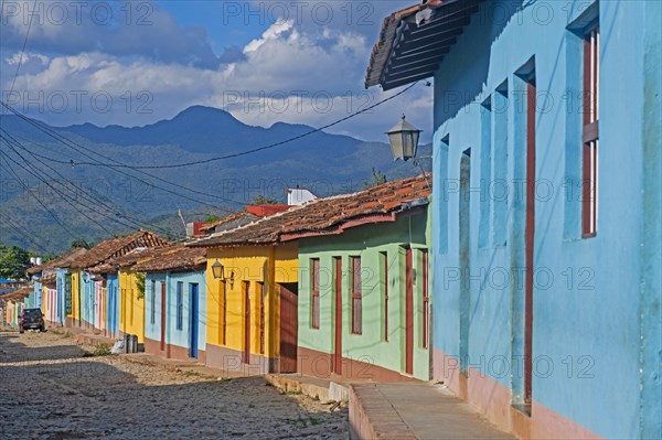 Colonial cobbled street with pastel coloured houses in the city Trinidad