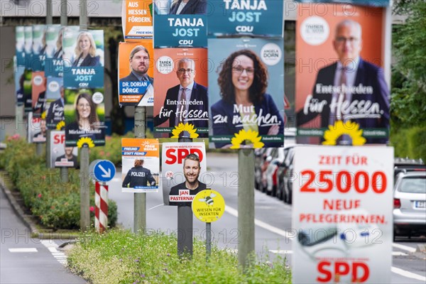 Election campaign posters on the occasion of the state election in Hesse on 08 October 2023 hang one after the other on several lampposts in Frankfurt am Main.