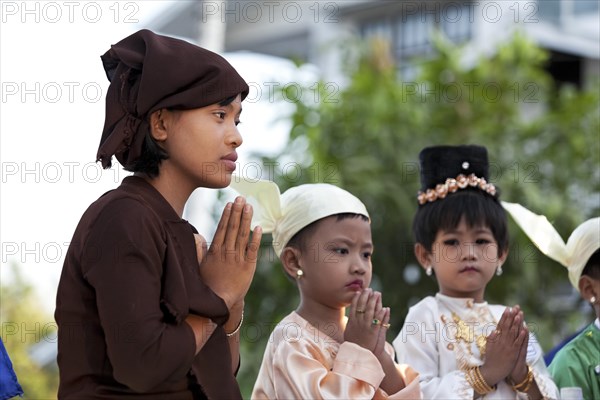 Young woman and children praying