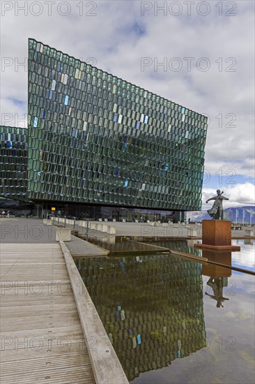 Sculpture The Musician by Icelandic sculptor Oloef Palsdottir in front of Harpa Concert Hall and conference centre in capital city Reykjavik