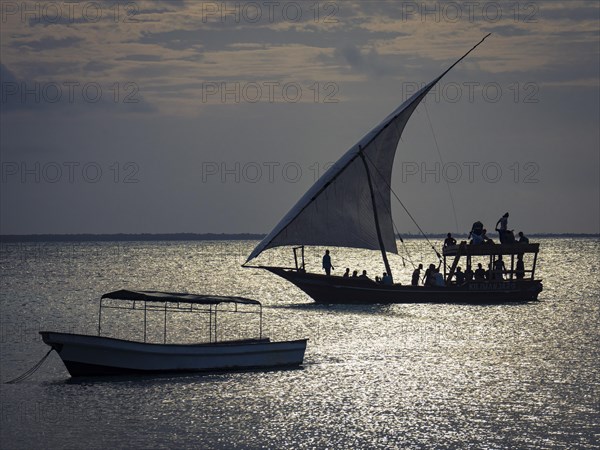 Silhouettes of boats in the glittering water