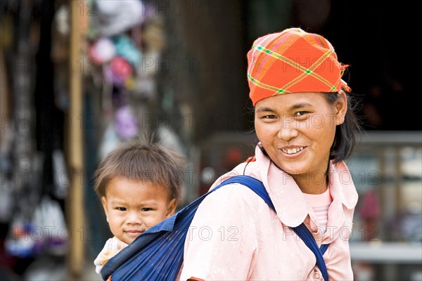 Mother carrying child in sling