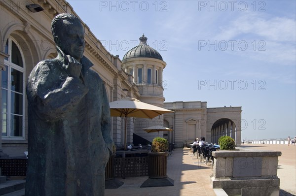 Bronze sculpture of King Baudouin and the Venetian Galleries at seaside resort Ostend along the North Sea coast