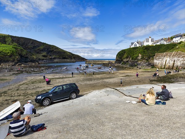 Pedestrians in the harbour at low tide