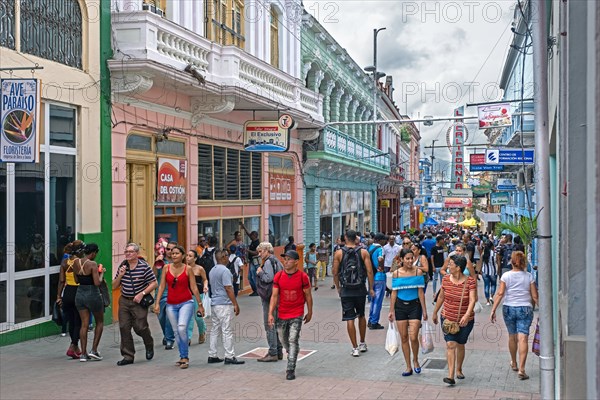 Streetscene showing shops and Cuban shoppers in shopping street in Santiago de Cuba