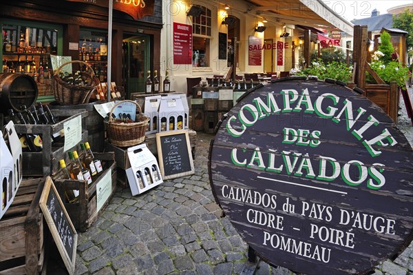 Regional products like cider and bottles of calvados in shop at Honfleur