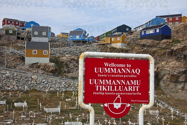 Uummannaq village with colourful houses and welcome sign of Santa's vacation paradise