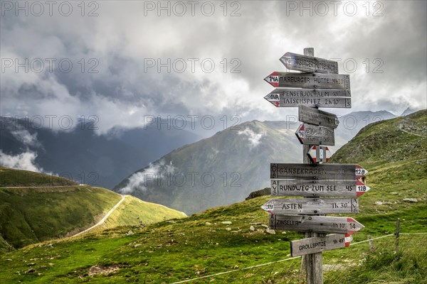 Wooden signpost showing directions on a mountain pass near Penser Joch