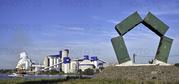 The cement factory CBR and artwork Speybank made of containers by artist Luc De Leu along the Ghent-Terneuzen Canal at Ghent seaport