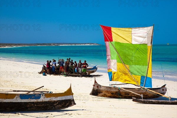 Outrigger boat with colourful sail on the beach