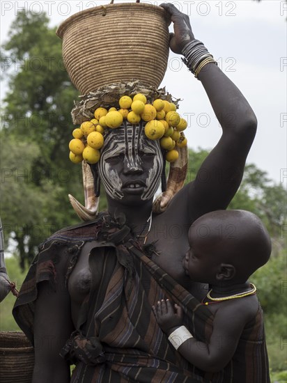 Woman with infant and headdress from the Mursi tribe
