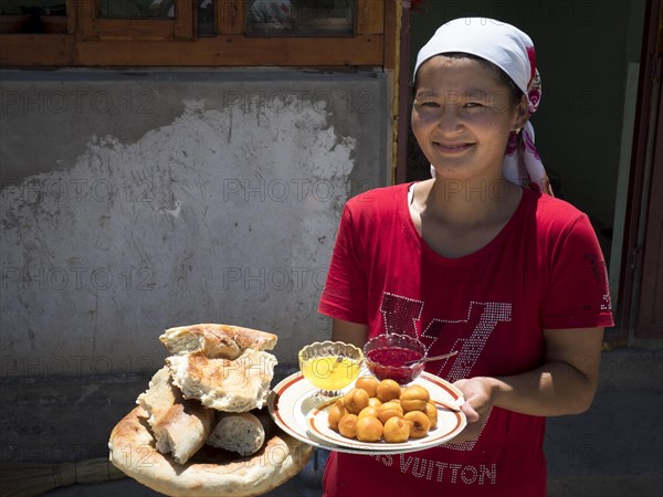 Young farmer's wife brings bread and fruit