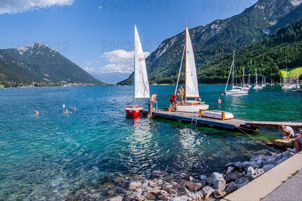 Jetty on the lake promenade with sailing boats