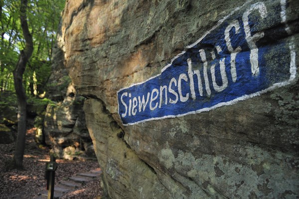 Siewenschlueff sign on sandstone rock at Wanterbaach in Berdorf