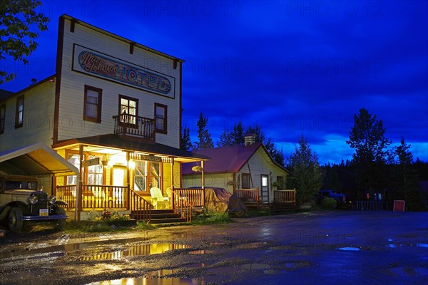 Evening illuminated facade of an old hotel