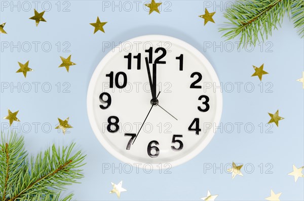 Front view midnight clock with golden stars pine leaves