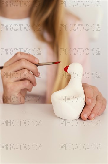 Close up hand holding painting brush