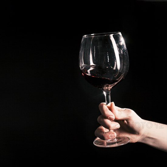 Crop hand with wineglass