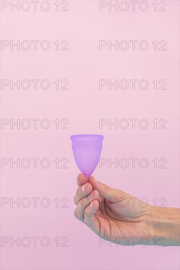 Hand holding menstrual cup