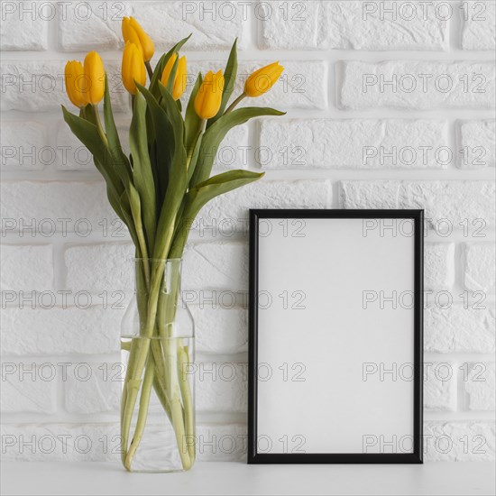 Bouquet tulips transparent vase with empty frame